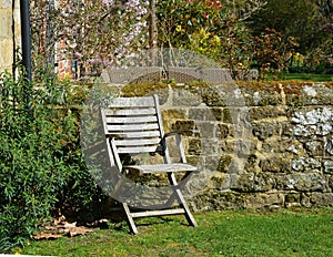 Relaxation chair in sunny corner of garden