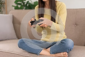 Relaxation concept, Young woman sitting on the couch to playing video games with joystick console