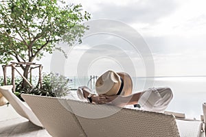 Relaxation holiday vacation of businessman take it easy happily resting on beach chair at swimming pool poolside beachfront