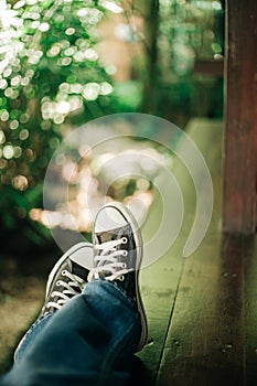 Relaxation.leg men wear black sneakers and jean.