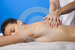 Relaxation. Masseur doing massage on woman body in the spa salon
