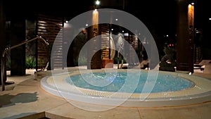 Relaxation pool in spa with waterfall. Empty luxury spa with jacuzzi and swimming pool. Jacuzzi in the sauna. Wellness