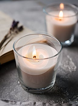 Relaxation with reading book and aromatic candlelight. Cozy domestic composition. Selective focus