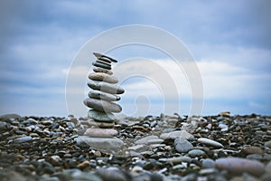 relaxation at sea. Stack of stones on beach - nature background.