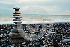 relaxation at sea. Stack of stones on beach - nature background.