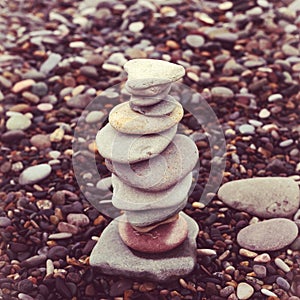 relaxation at sea. Stack of stones on beach nature background. Stone cairn on blurry background, pebbles and stones