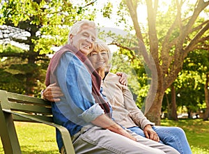 The relaxation starts now. Portrait of a happy senior couple relaxing on a park bench.