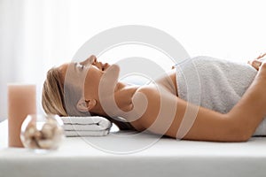 Beautiful Middle Aged Woman Lying On Massage Table In Luxury Spa Salon