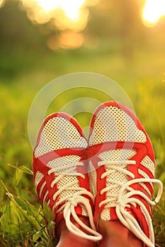 Relaxation. youth sneakers girl legs on grass, sunny day, instagram look.