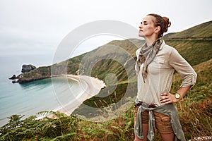 Relaxed active woman hiker in front of ocean view landscape