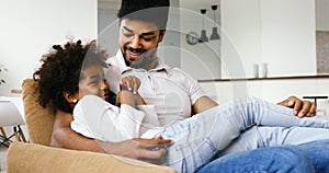 Relaxed african american family watching tv