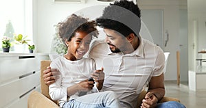 Relaxed african american family watching tv