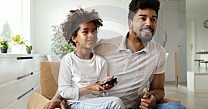 Relaxed african american family watching tv