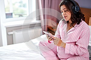 Relaxed attractive pregnant female beging morning with music photo