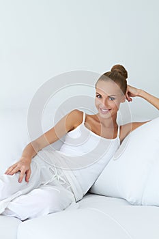 Relaxed beautiful woman sitting on couch