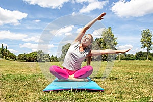 Relaxed blond woman doing yoga with bent upper body