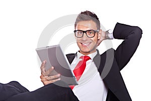 Relaxed business man using electronic pad tablet