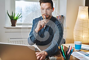 Relaxed business man working on laptop