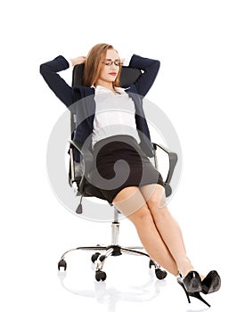 Relaxed business woman sitting on a chair with closed eyes.