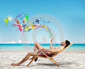 Relaxed businessman on a deckchair with his mobile phone