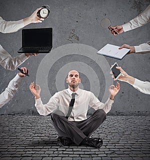 Relaxed businessman that does yoga during the work