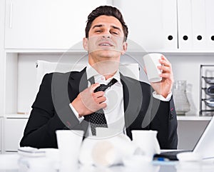 Relaxed businessman finishing work