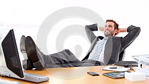 Relaxed businessman putting his feet up