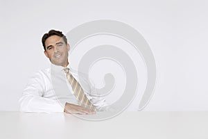 Relaxed Businessman Sitting At Desk In Office