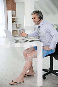 Relaxed businessman on video meeting at home