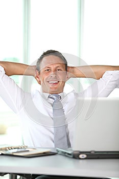 Relaxed businessman at work photo