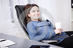 Relaxed businesswoman enjoying her coffee break