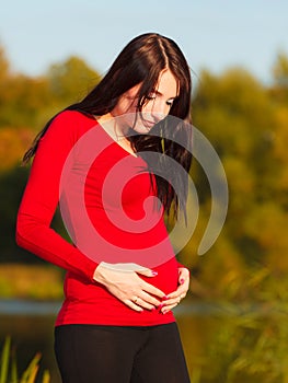 Relaxed calm pregnant woman in park outdoor