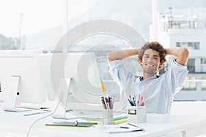 Relaxed casual business man with computer in bright office