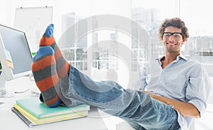 Relaxed casual man with legs on desk in office