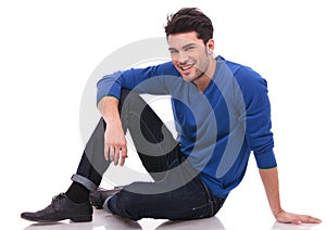 Relaxed casual man sitting on white background