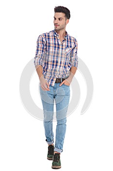 Relaxed casual man walking and looking to side