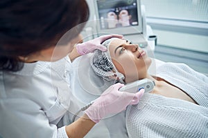 Relaxed charming woman getting skin care treatment