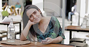 Relaxed confident young woman at a restaurant