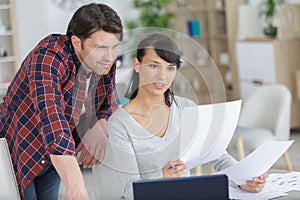 relaxed couple doing their accounts at home