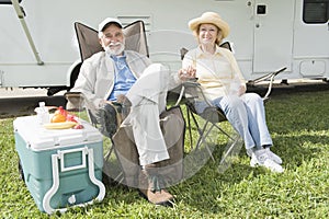 Relaxed Couple Sitting In Folding Chairs photo