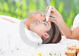 Relaxed Couple Undergoing Therapies At Spa photo