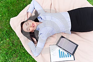 Relaxed delighted woman resting on the blanket