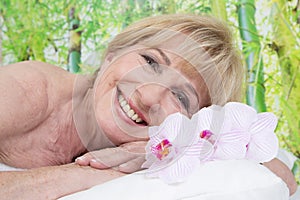 Relaxed elderly woman in spa