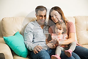 Relaxed family staring at a cell phone