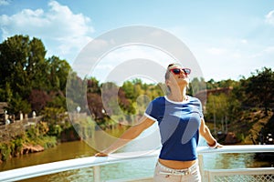 Relaxed fit woman on river boat enjoying river cruising