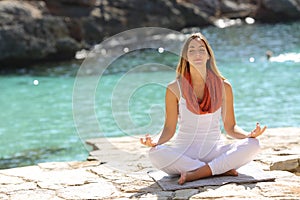 Relaxed girl doing yoga exercises on holidays