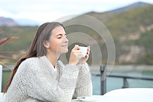 Relaxed girl drinking in a coffee shop terrace