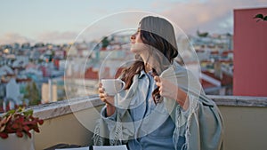 Relaxed girl drinking tea at sunrise view balcony closeup. Lady sipping coffee