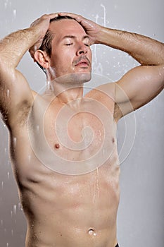 Relaxed Handsome macho man guy holding hands touch perfect hairdo topless, get shower