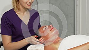Relaxed happe woman getting head massage at spa center